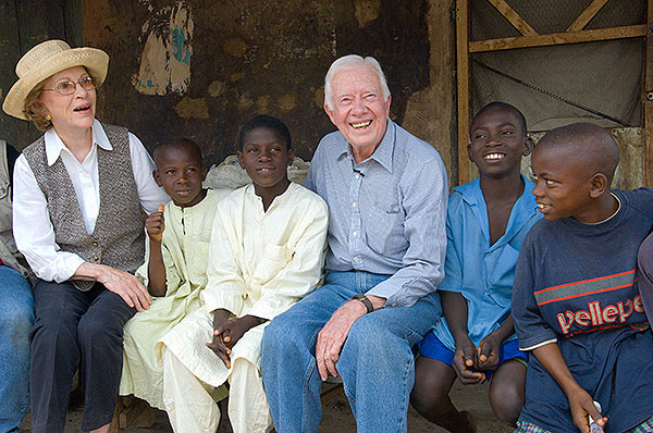 Jimmy and Rosalynn Carter pose with four young boys in Nigeria.