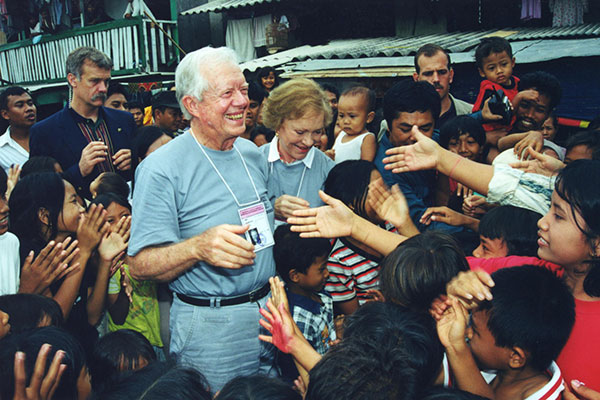 Jimmy and Rosalynn Carter greet a crowd.