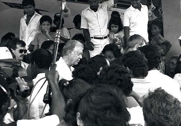 Jimmy Carter surrounded by media.