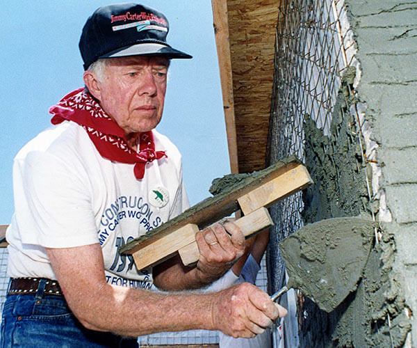 Jimmy Carter helps with the construction of a home.