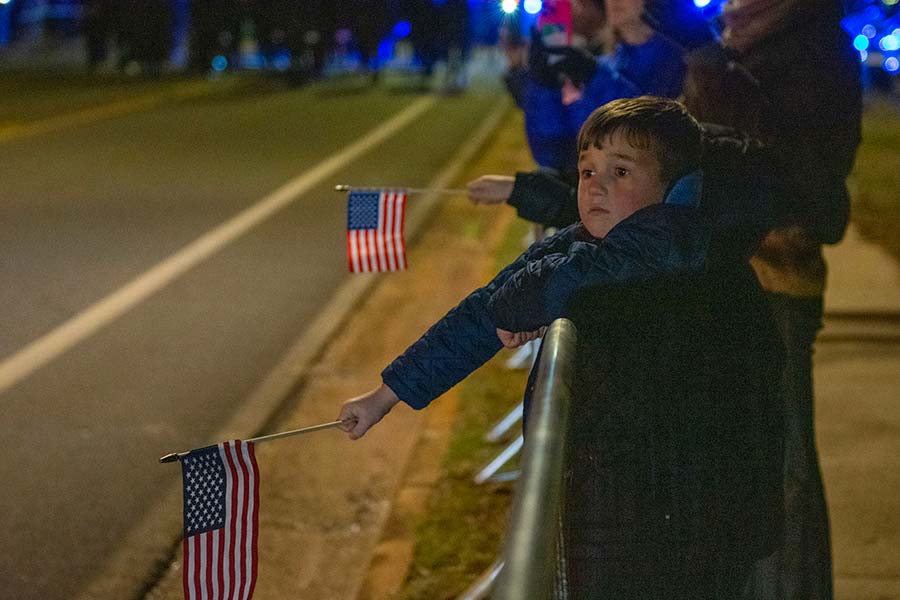 A child waits for President Carter’s funeral procession.