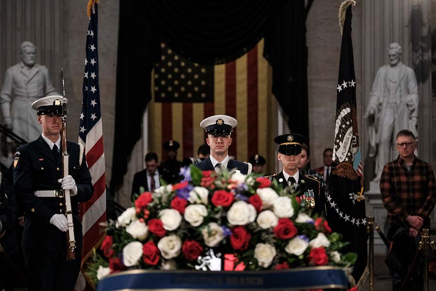 Military guard of honor stands watch over  President Carter's casket.