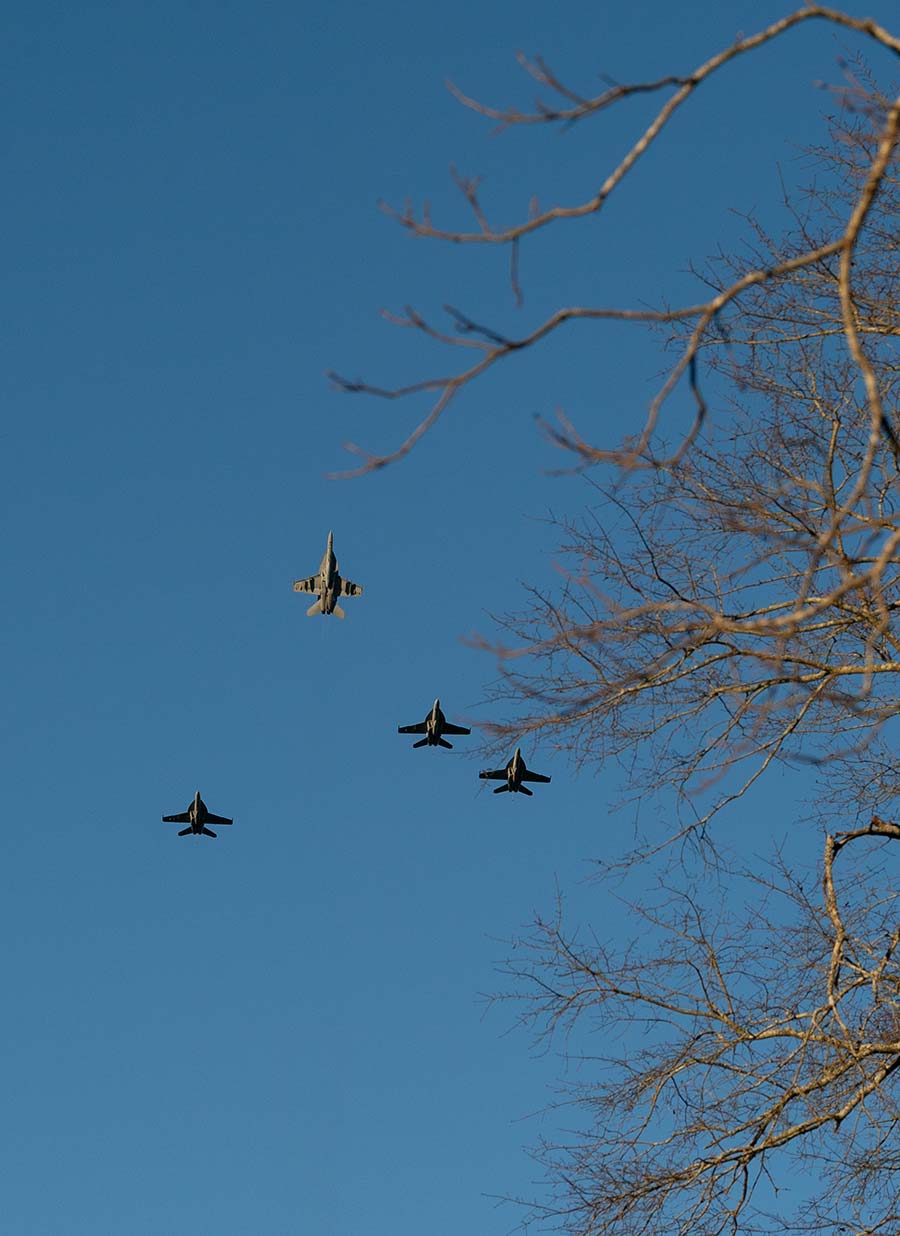 A U.S. Navy fighter jet peels away.