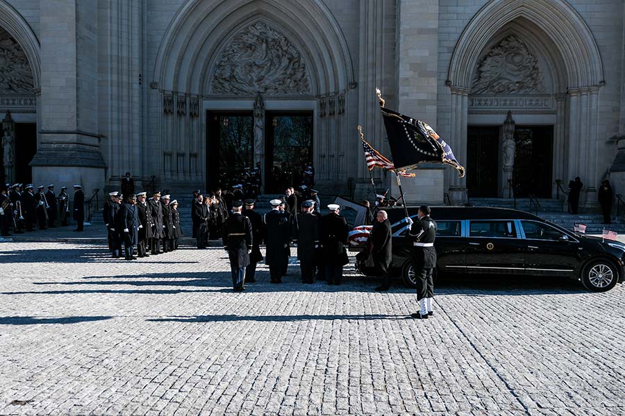 Bearers from all branches of the military prepare to carry President Carter’s casket into Washington National Cathedral.