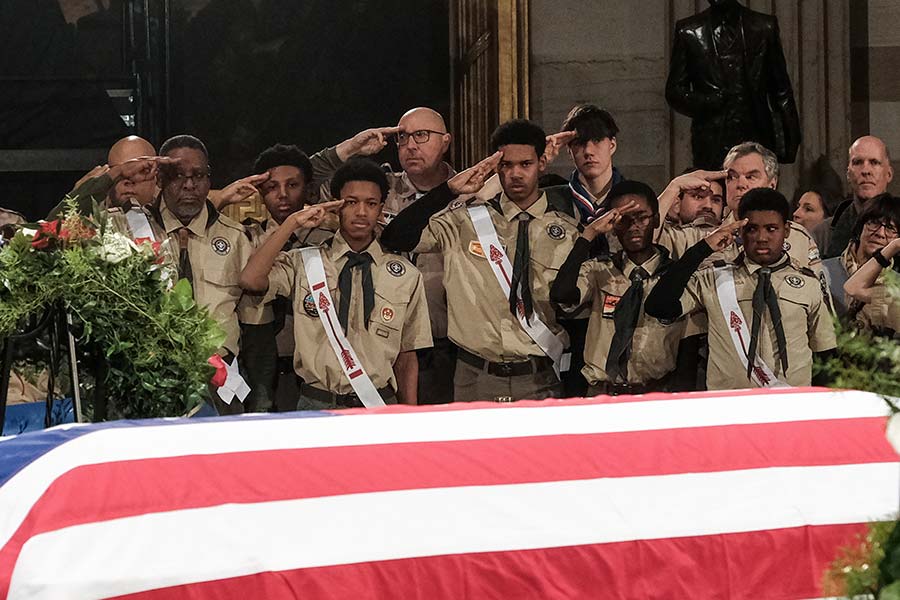 Scouts salute President Carter’s flag-draped casket.