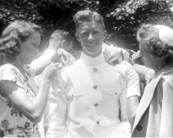 Lillian Carter and Rosalynn Smith pinning epaulets on Jimmy.