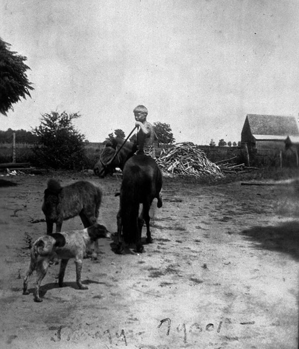 Jimmy Carter as a young boy atop a pony.