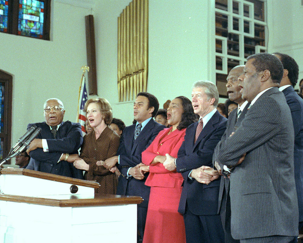 President and Mrs. Carter singing alongside Andrew Young, Coretta Scott King, and others at Ebenezer Baptist Church.