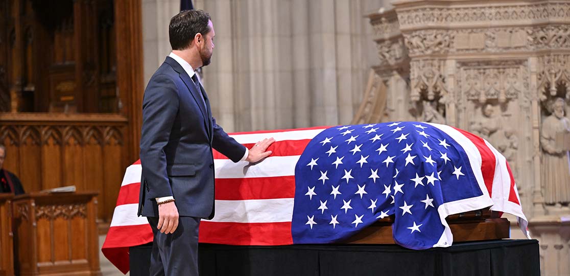 Jason Carter touches casket