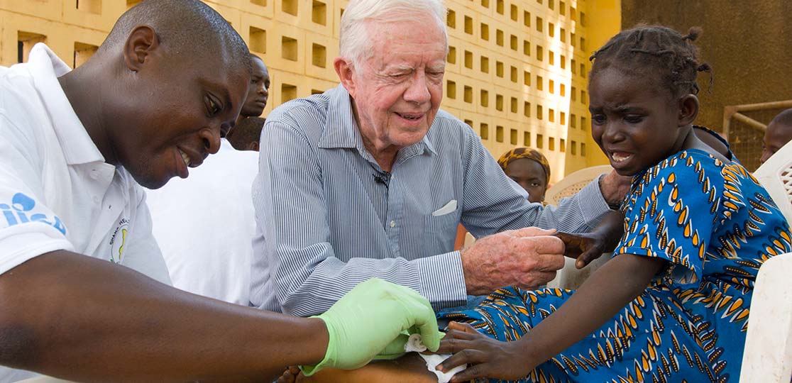 Jimmy Carter comforts Guinea worm patient